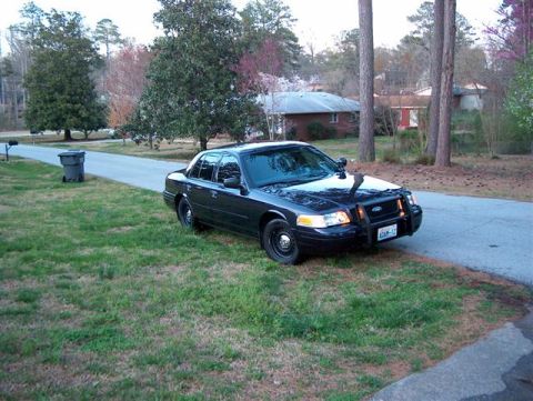 2001 Ford Crown Victoria - This Ford Crown Victoria Police Interceptor is parked on the side of a residential street.