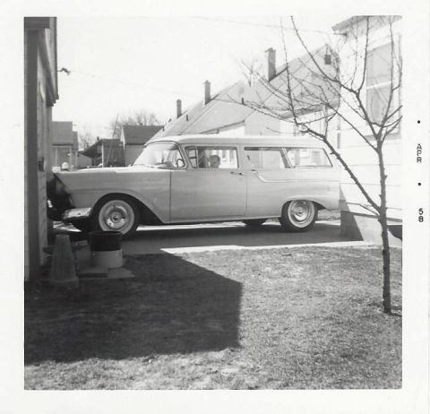 1996 Ford Bronco - Side view of a 1958 Ford Fairlane Country Squire station wagon parked by a house.