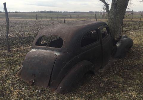 1967 Ford Custom Wagon - This old car body sits abandoned in a field, its rusty shell a testament to time.