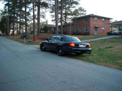 2001 Ford Crown Victoria - This 2001 Ford Crown Victoria is seen from the rear, parked on the side of a residential street.