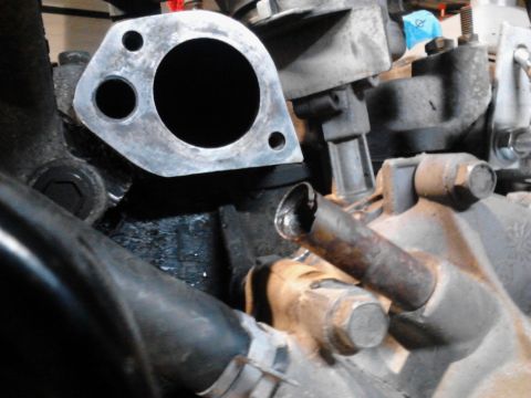 1995 Ford Bronco - This is a close-up view of an engine component, possibly an exhaust manifold or intake part.