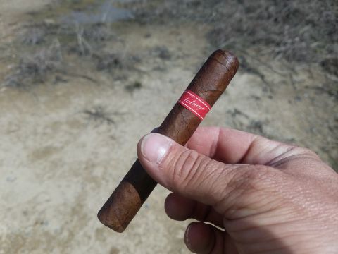 2018 Ford Bronco - A hand holds a cigar with a red band.