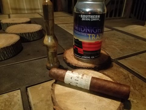 2018 Ford Bronco - A cigar and a can of Southern Brewing Company's Midnight Train Porter are displayed on wooden coasters.