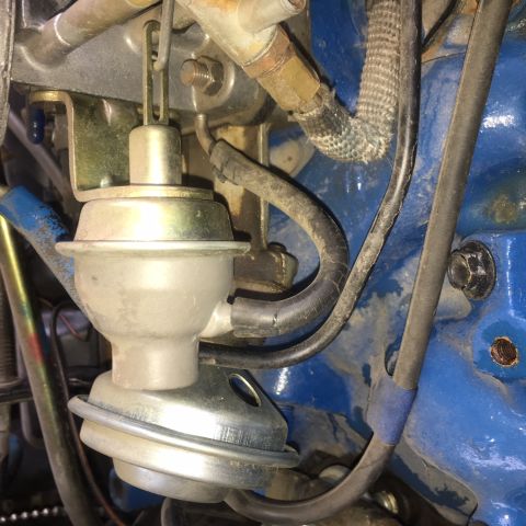 1979 Ford Ranchero - This image shows a close-up view of a vacuum diaphragm and associated hoses within an engine compartment.