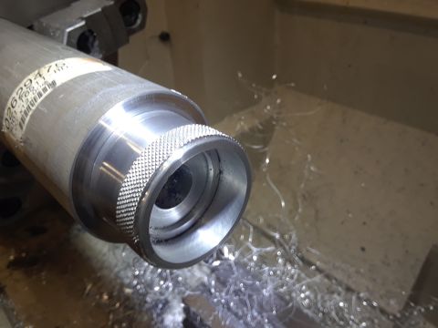 1994 Ford Bronco - A metal part is being machined on a lathe, with metal shavings accumulating in the work area.