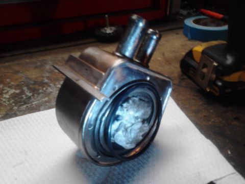 1995 Ford Bronco - A heater control valve sits on a workbench, ready for installation or repair.