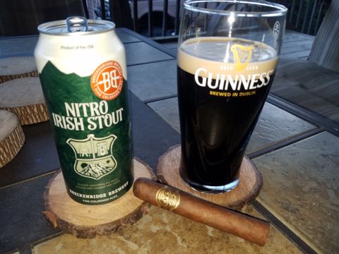 2018 Ford Bronco - A can of Breckenridge Brewery Nitro Irish Stout, a glass of Guinness, and a cigar rest on wooden coasters on an outdoor table.