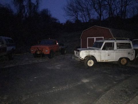 1967 Ford Bronco - White 1967 Ford Bronco parked near a red barn with another vehicle in the background.