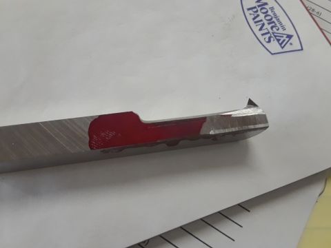 1994 Ford Bronco - Metal cutting tool with red marking shown on paper with paint logo and website.