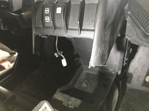 1988 Ford Bronco - Interior view of a vehicle's dashboard, showing the four-wheel drive selector and damaged trim.