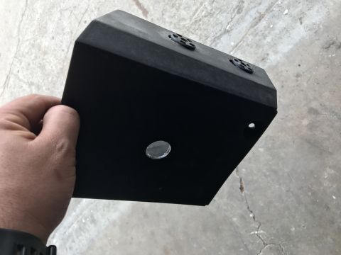 1988 Ford Bronco - Black metal component with multiple holes, held by a hand.