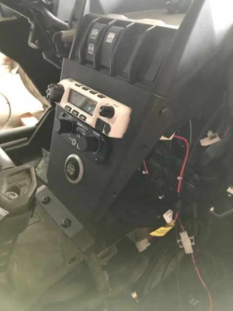 1988 Ford Bronco - The interior of an off-road vehicle shows a mounted radio and wiring, with a push-to-start button visible.