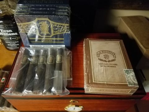 2018 Ford Bronco - A collection of cigars and a bottle of Kentucky Bourbon are displayed on a wooden surface.
