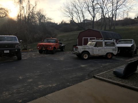 1967 Ford Bronco - Several vehicles, including a 1967 Ford Bronco, are parked outside a barn.