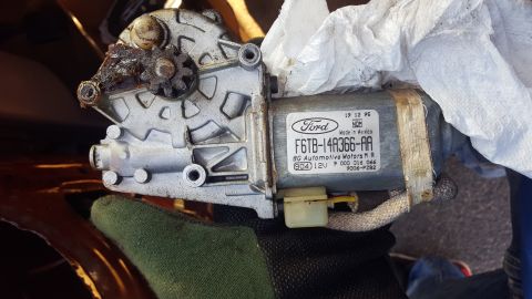 1967 Ford Bronco - Close-up of a Ford window motor assembly, part number F6TB-14A366-AA.