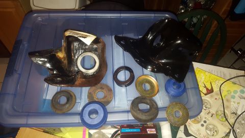 1967 Ford Bronco - Various automotive parts and washers are laid out on a blue storage bin.