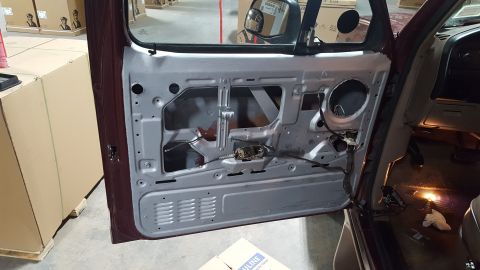 1967 Ford Bronco - The interior of a vehicle door is exposed, revealing its internal components and wiring.
