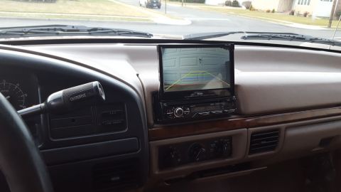 1967 Ford Bronco - The dashboard shows an aftermarket backup camera display, indicating a modern addition to an older vehicle.