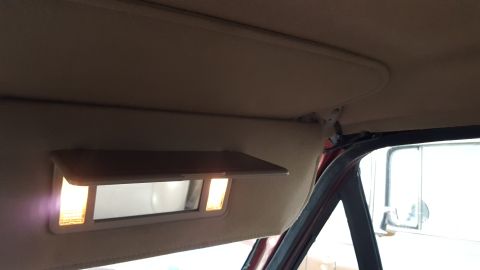 1967 Ford Bronco - The illuminated vanity mirror is visible inside the vehicle's cabin.