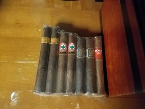 2018 Ford Bronco - A package of seven cigars is displayed on a wooden surface next to a wooden box.