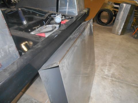 1992 Ford Bronco - Workshop scene with vehicle chassis, engine parts, and fabricated metal sections.