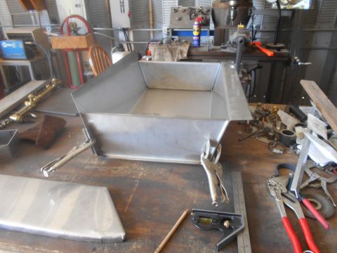 1992 Ford Bronco - Metal fabrication project in progress on a workbench with various tools and clamps.
