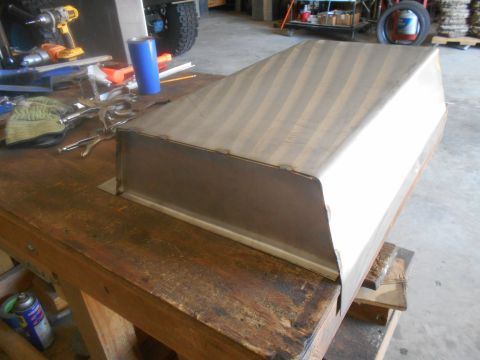1992 Ford Bronco - A metal box is being worked on in a garage setting, with tools and a vehicle tire visible.