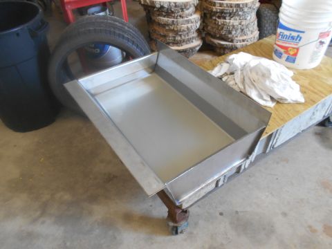 1992 Ford Bronco - A metal drip pan sits on a workbench with a tire and bucket nearby.