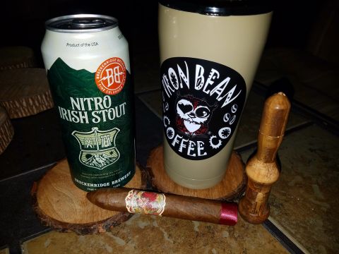 2018 Ford Bronco - A collection of items including a nitro Irish stout beer can, a coffee tumbler, a cigar, and a tamper are arranged on a surface.