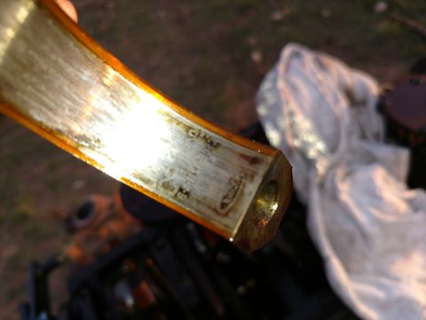 1996 Ford Bronco - Close-up of an engine bearing with visible wear and oil residue, displaying faint markings.