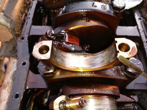 1996 Ford Bronco - Engine crankshaft bearing showing signs of wear, likely needing replacement.