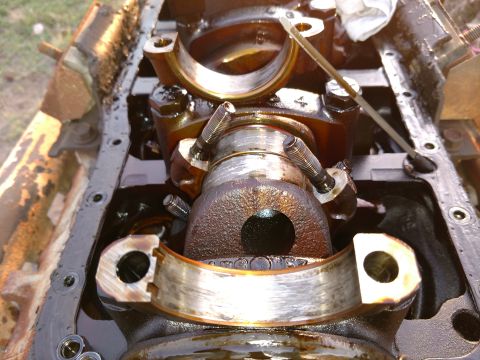 1996 Ford Bronco - The crankshaft and bearing surfaces show significant wear, indicating a need for repair or replacement.