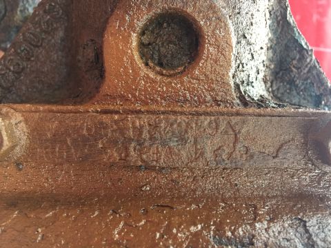 1967 Ford Custom Wagon - A close-up view of a rusty cast iron component with visible stamped markings.