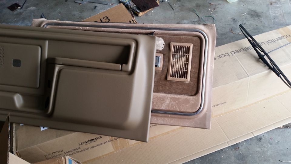 Tan interior door panel and vehicle interior section on cardboard.