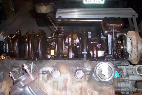 1995 Ford Bronco - This image shows the internal components of a V8 engine, likely a Ford Bronco, with the crankshaft, connecting rods, and oil pan visible. T…