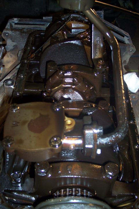 1995 Ford Bronco - This is a close-up, overhead view of the internal components of an engine, likely a Ford Bronco based on the provided context. The engine a…