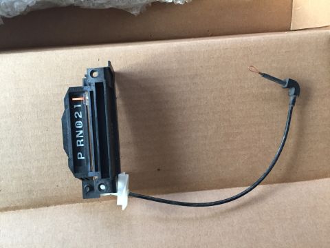 1967 Ford Custom Wagon - A black automatic transmission gear shift indicator with white lettering showing P, R, N, 0, 2, 1 is shown with a black cable attached.