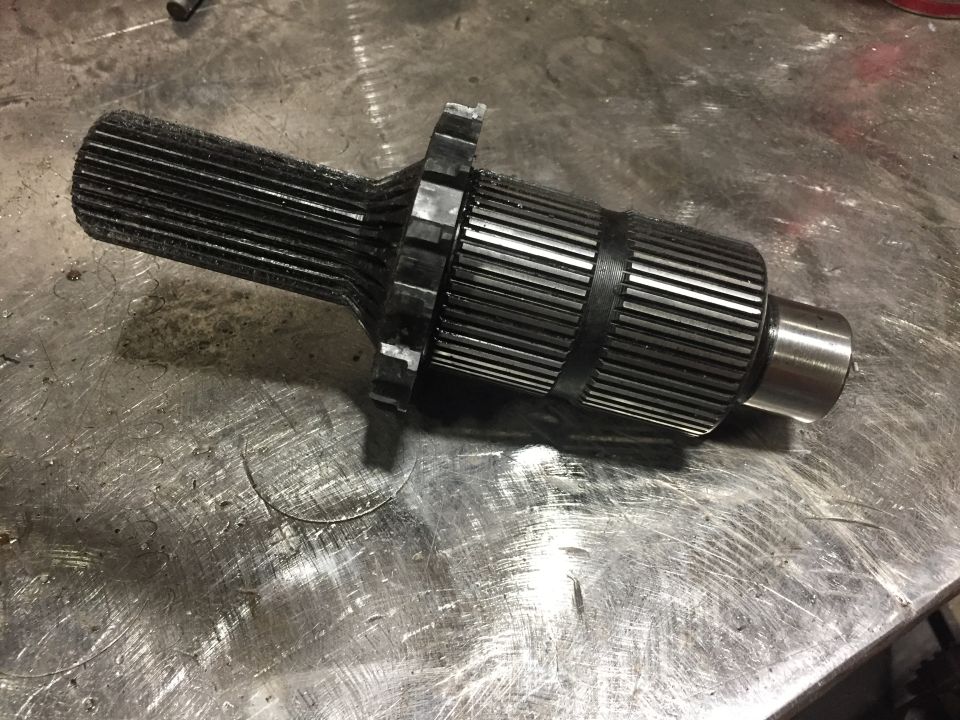 Splined shaft with gear component on metal surface