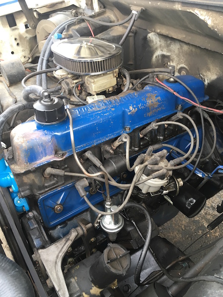 1981 Ford Bronco - Close-up view of a blue Ford V8 engine, likely from a 1981 Ford Bronco. Visible components include the carburetor, air filter, valve covers…