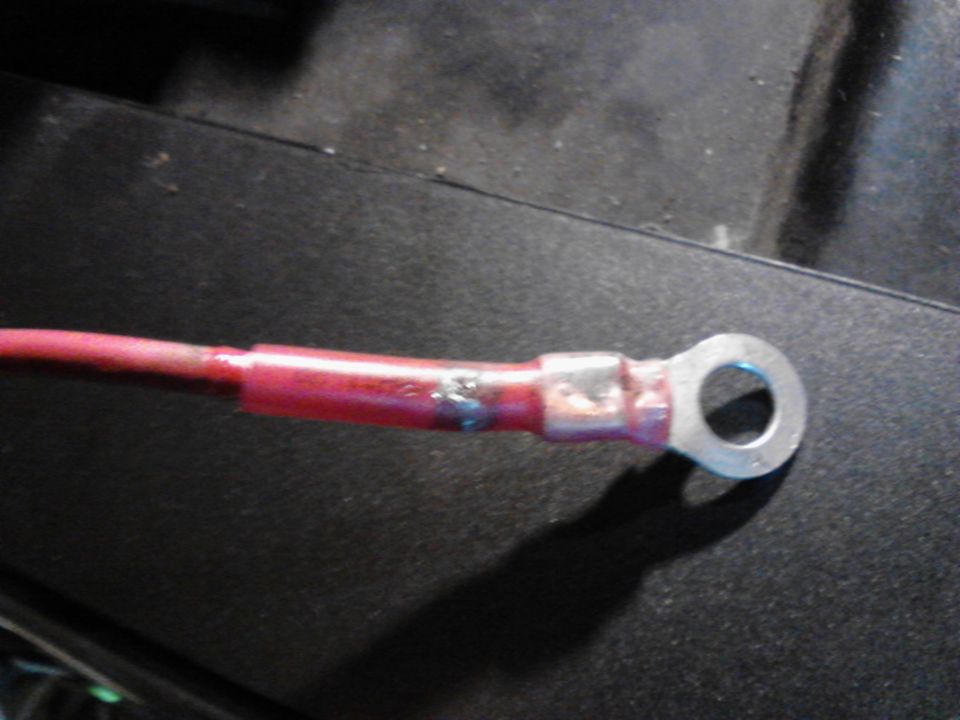 Red insulated wire with a silver ring terminal.