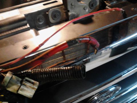 1995 Ford Bronco - Close-up view of red wiring and a black corrugated conduit connected to a white electrical connector, possibly in the engine bay of a vehic…
