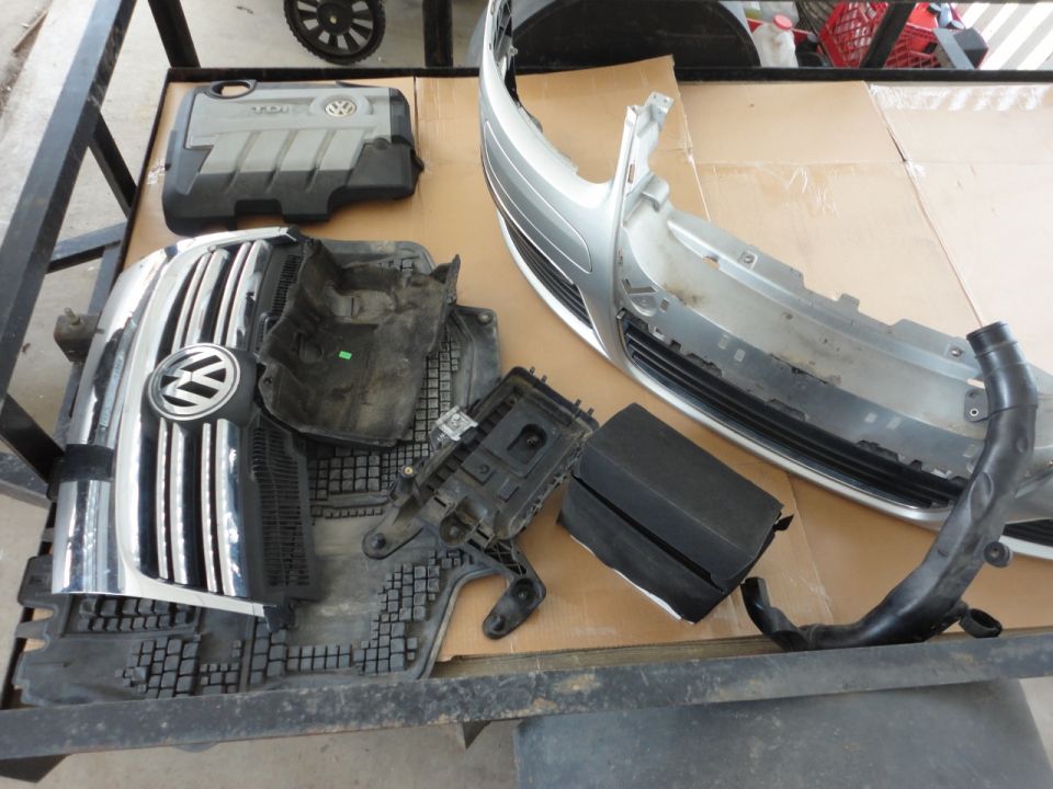 Volkswagen Jetta TDI engine parts and body panels on a table