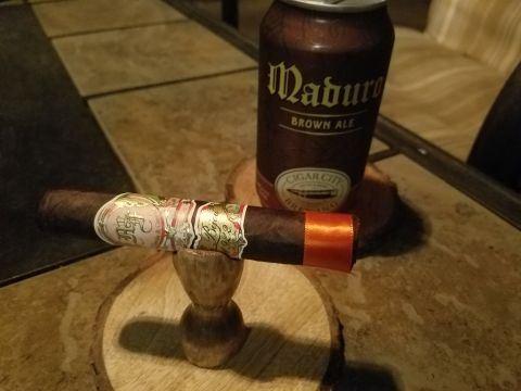 2018 Ford Bronco - A cigar rests on a wooden stand beside a can of Maduro Brown Ale.