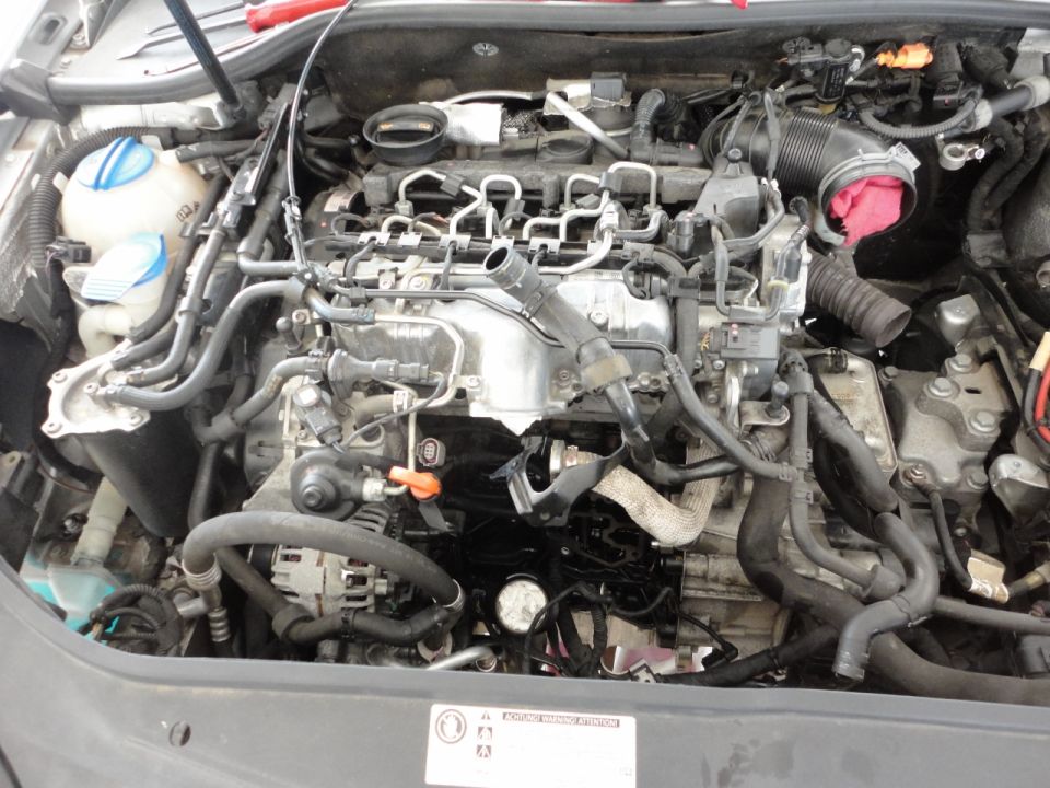 Close-up of a Volkswagen Jetta TDI engine bay with hoses and wires.