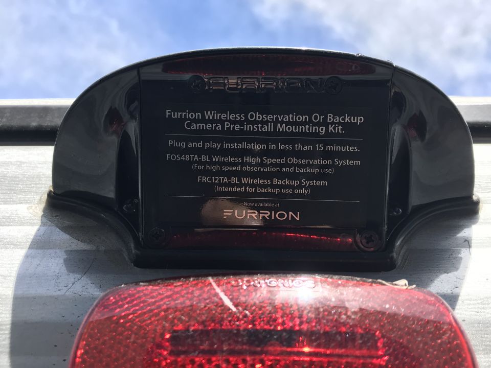 Black Furrion camera mounting kit with text on a vehicle rear.