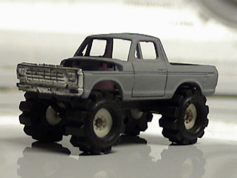 1979 Ford Bronco - This toy truck features oversized tires and a lifted suspension, resembling a modified classic pickup.