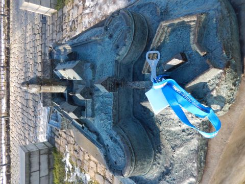 2010 Audi A4 - A bottle opener and lanyard are attached to a bronze sculpture depicting buildings.