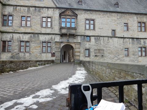 2010 Audi A4 - A view of a historic stone castle entrance with a cobblestone pathway leading through an arched gateway.