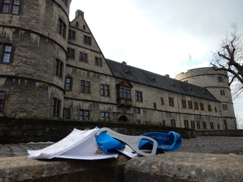 2010 Audi A4 - Papers and a bottle opener rest on a stone wall in front of a large, historic castle.