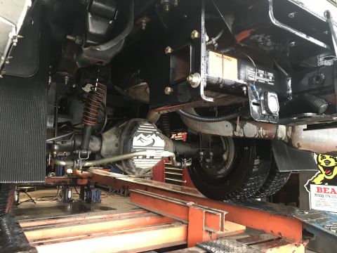 1997 Dodge 3500 - The underside of a truck is visible, with a focus on the rear axle and suspension components.